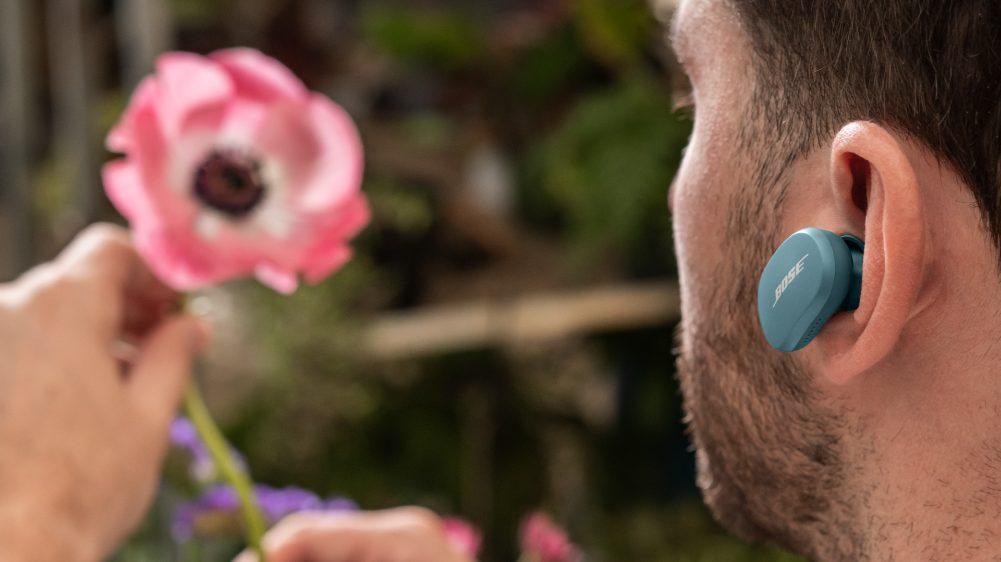 A man wearing Bose QuietComfort Earbuds in his ears