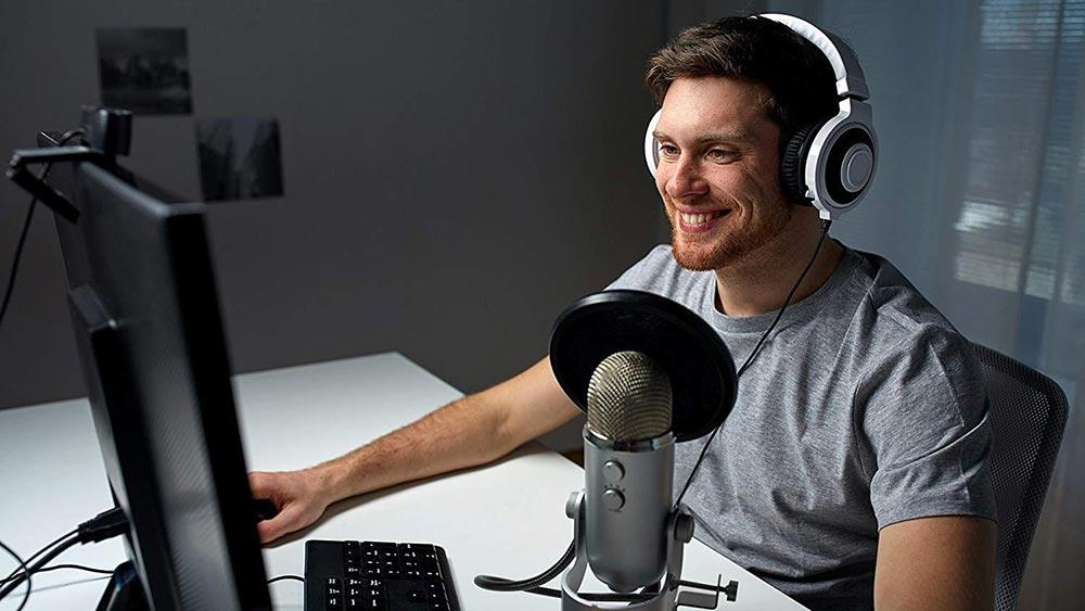 Man using Blue Yeti microphone with pop filter