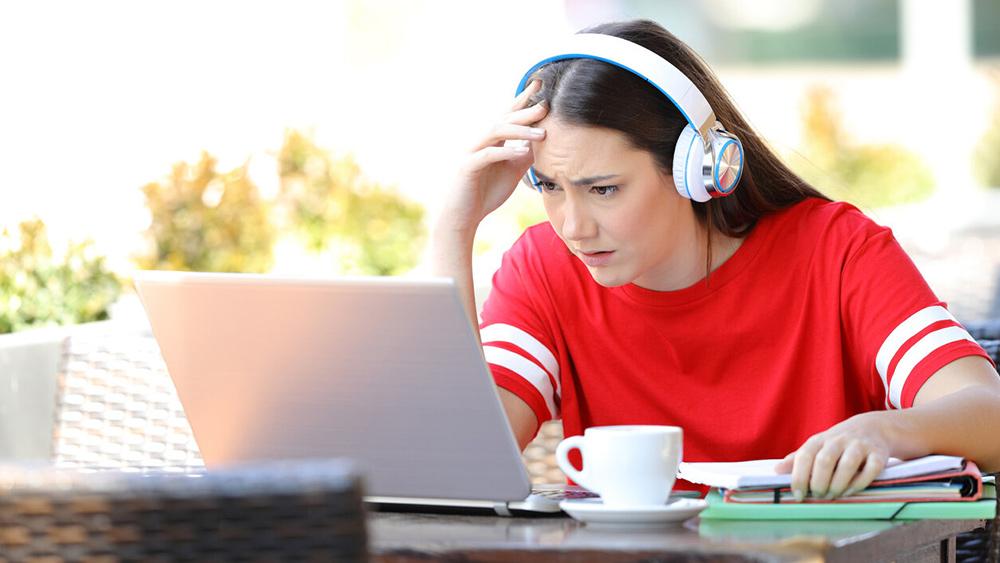 girl wearing headphones frustrated