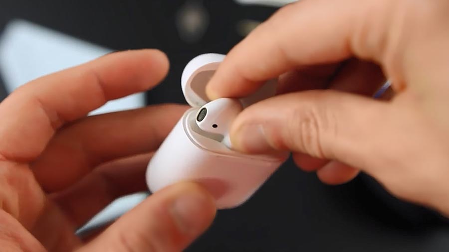 Returning Airpods to the charging case.